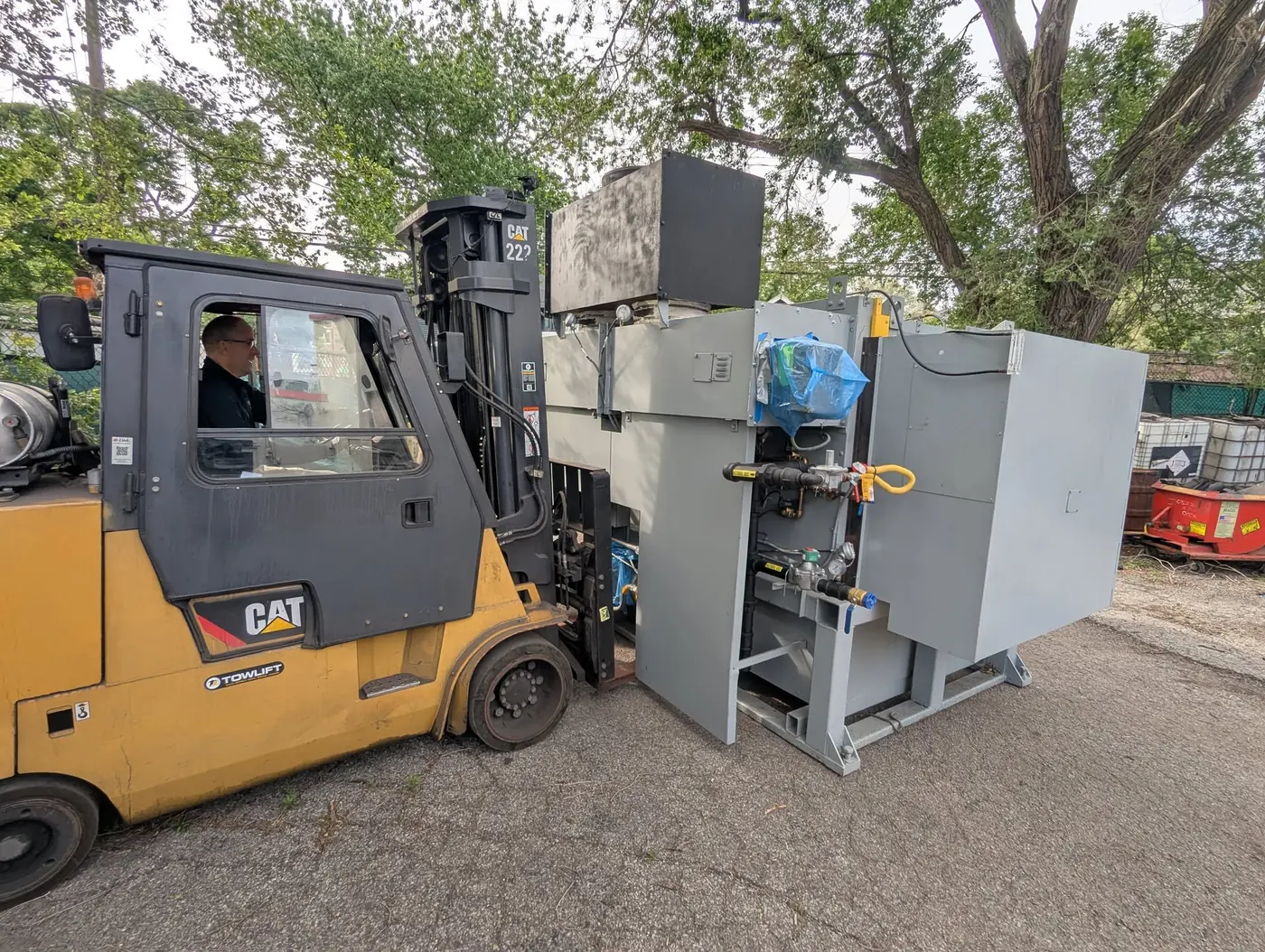 Compact furnace being moved by forklift following pumpout